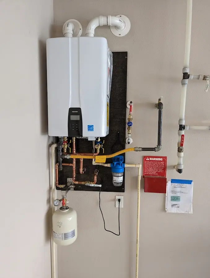 Professional plumber installing copper piping in a Timberlake home